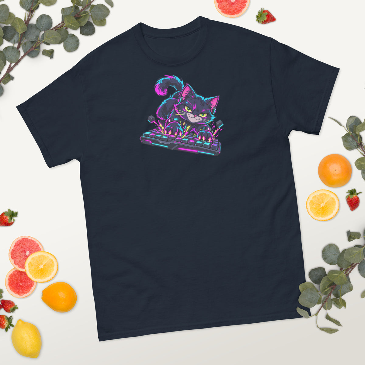 Digital mockup: navy Keyboard Kitty T-shirt laid flat with fruit and greenery.